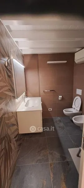 Bathrooms - Elegant Trilocale with Private Patio in Como